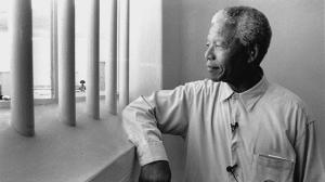 Photo: Nelson Mandela revisits his prison cell on Robben Island in 1994, where he had spent 18 of his 27 years in prison. (Getty Images)